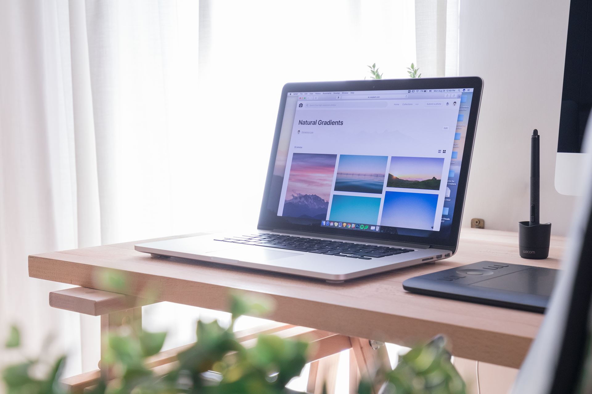 a laptop computer sitting on top of a wooden desk